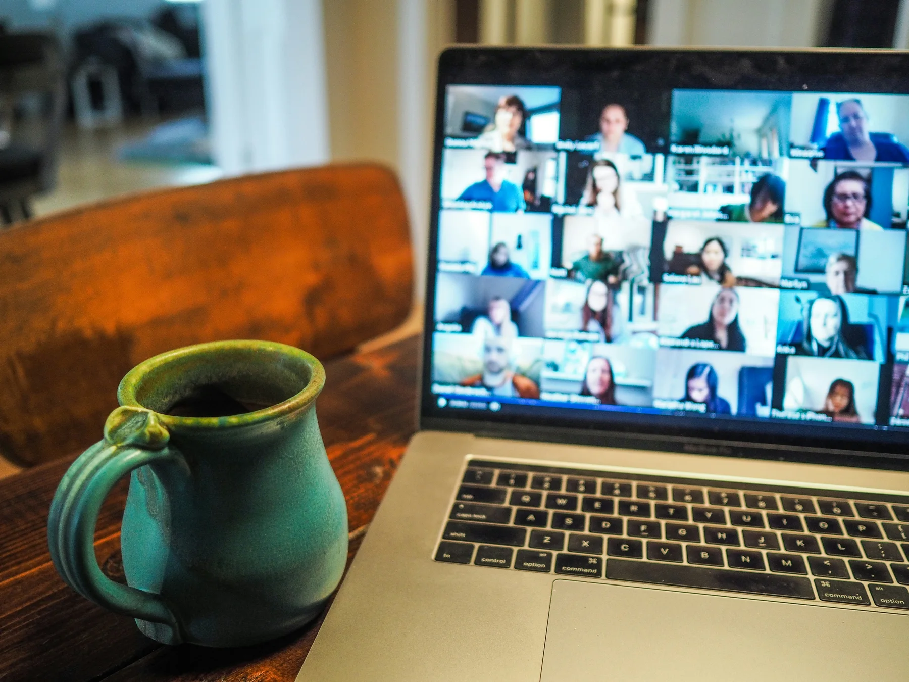 Laptop showing a global online learning session with a mug on the table